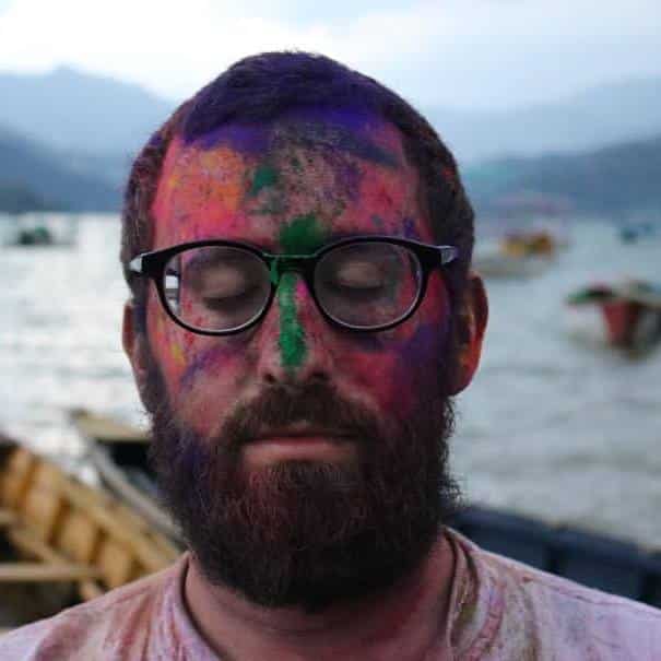 Kevin Ellerton, with Holi colors on his face
